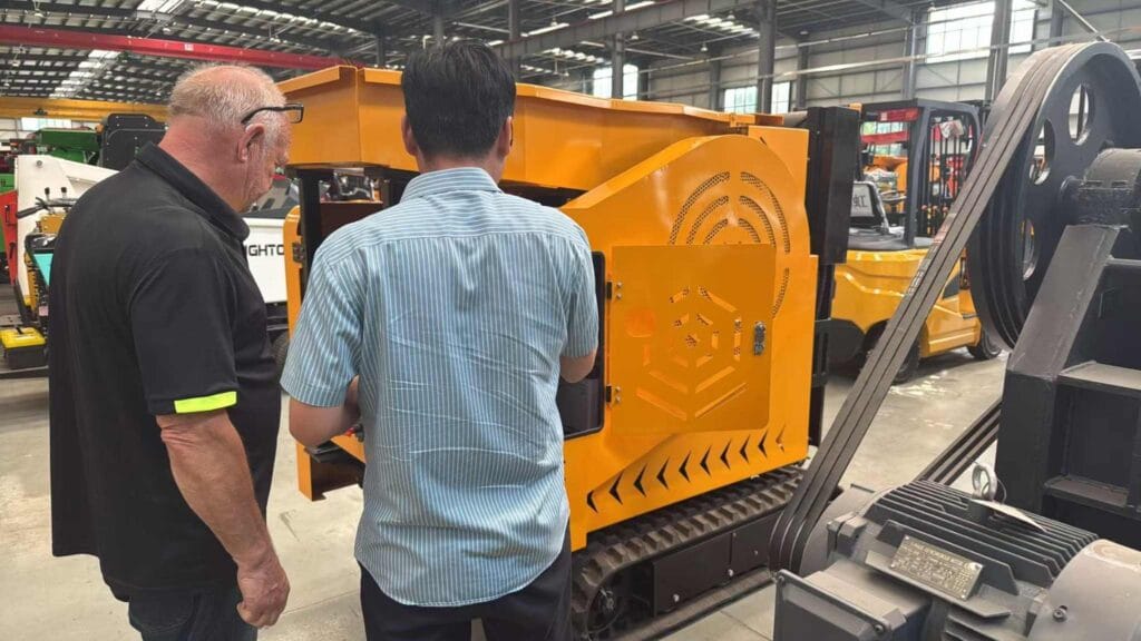 UK customer inspecting LUYUE mobile jaw crusher at the factory
